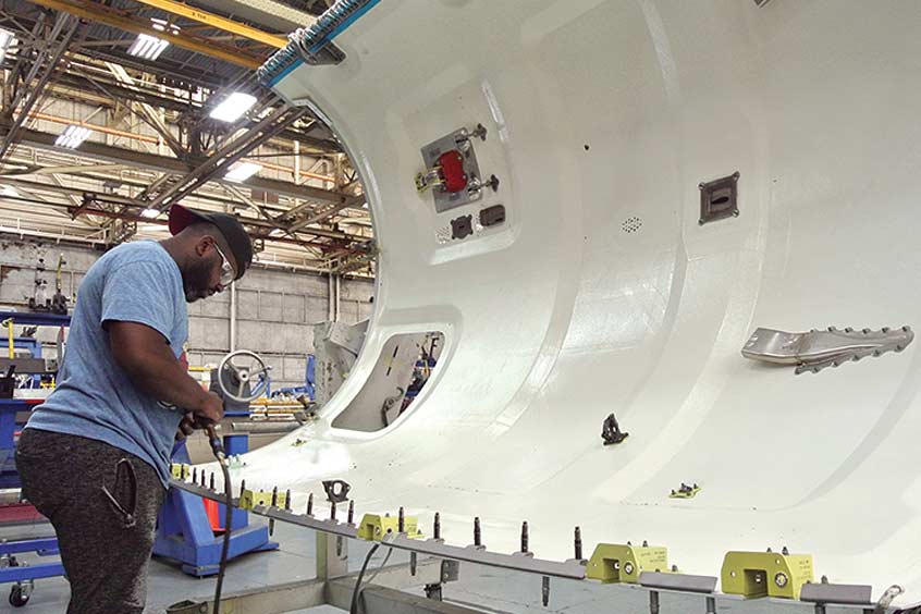 The composite upper fan cowl for Nexcelle’s 200th Passport engine nacelle undergoes final manufacturing at Middle River Aerostructure Systems. (Photo: Nexcelle) 