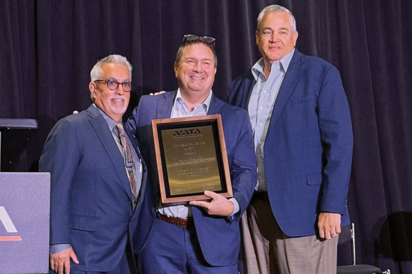 NATA CEO Curt Castagna (L) presents Andy Priester (centre) with award for Distinguished Service.